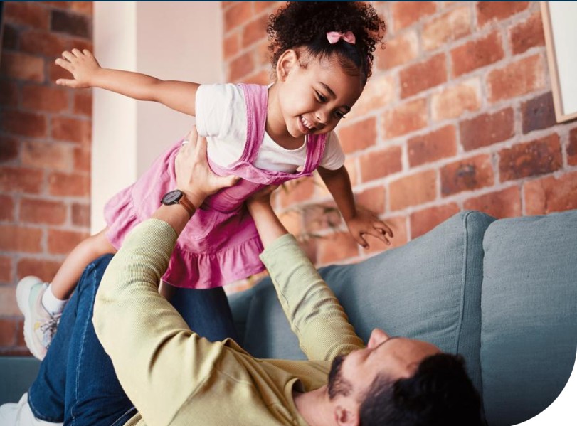 Dad playing airplane with his daughter